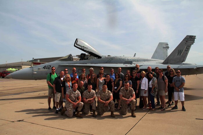 Educators from the Twin Cities area pose in front of an F-18 Hornet with their local Marines, during their visit to Marine Corps Air Station Miramar as part of the 2016 Educators Workshop. During the workshop, these educators visited several key Marine Corps instillations, fired live M-16 service rifles and navigated through the bayonet assault course at Marine Corps Recruit Depot San Diego.  