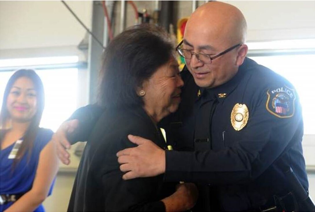 Chuepheng Lo hugs his mother, Khou Lo, during a promotion ceremony to chief of police for the Defense Logistics Agency San Joaquin Police Department in Tracy. 