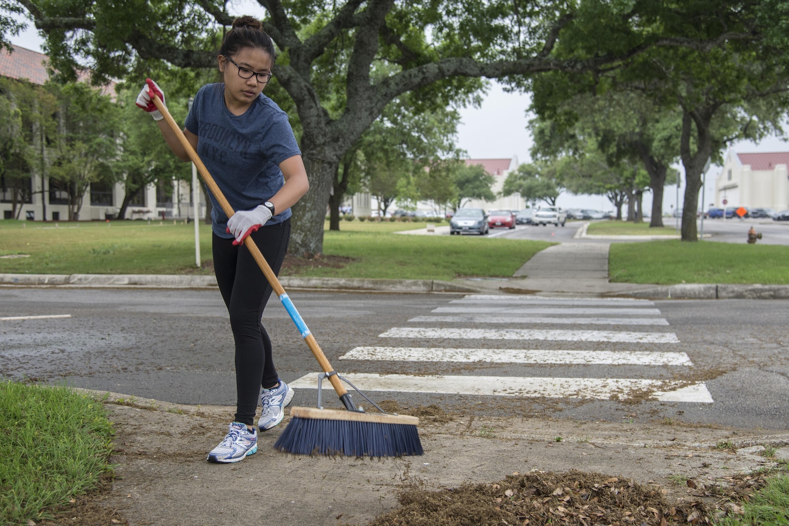 Airman 1st Class Marnela Tan, Air Force Personnel Center/DP2 tech-school assignments apprentice, sweeps the side walk outside the AFPC headquarters building April 11 at Joint Base San Antonio-Randolph. The 502nd Air Base Wing in coordination with the 502nd Civil Engineer Squadron conducted Proud Week Spring Cleanup to unite mission partners, tenant units, organizations and agencies throughout JBSA in an effort to enhance the appearance and beautification of JBSA and its facilities, conduct environmental maintenance and create a clean work environment.