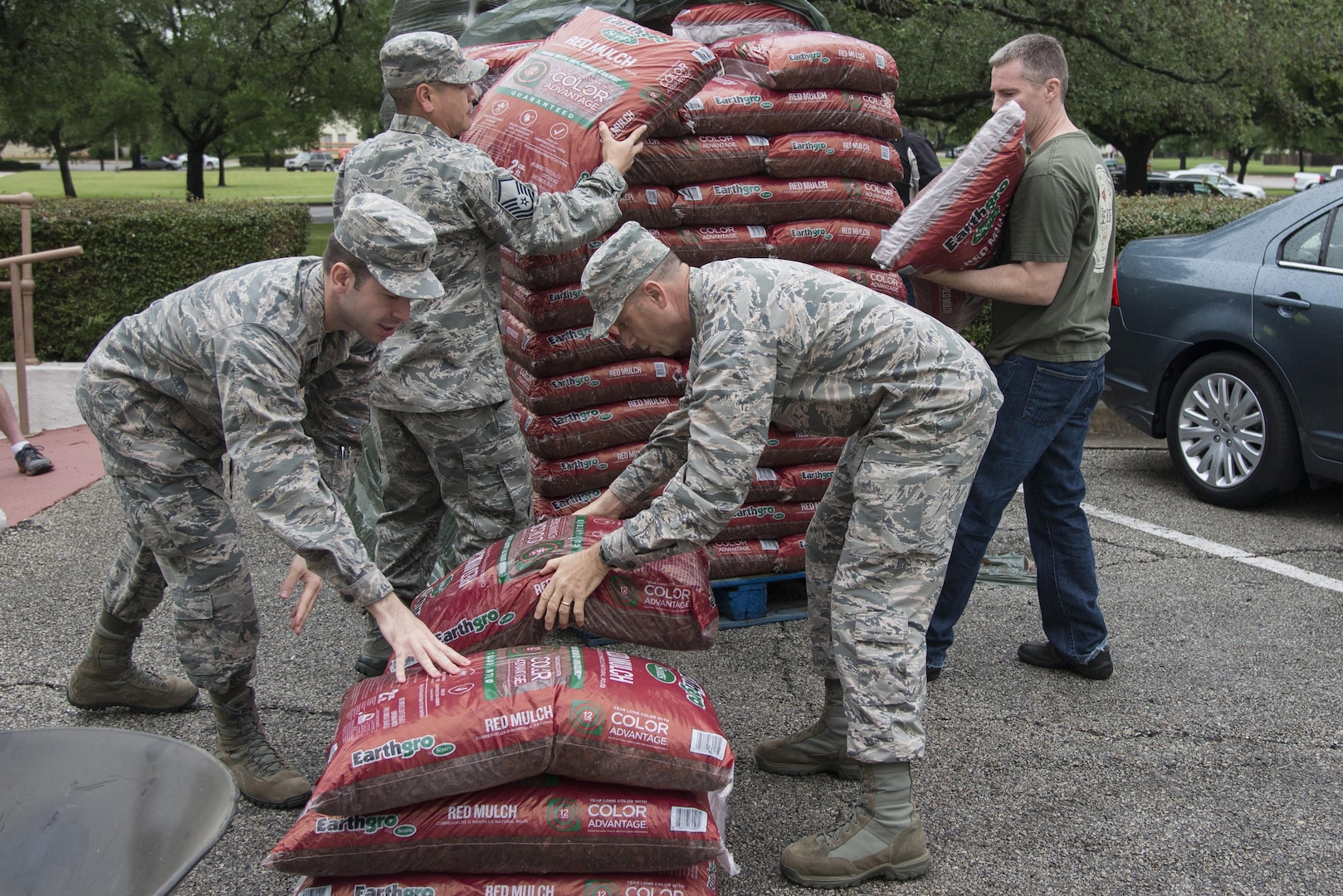 Members of the 502nd Security Forces and Logistics Support Group unload bags of mulch at the Taj during Proud Week April 13 at Joint Base San Antonio-Randolph. The 502nd Air Base Wing in coordination with the 502nd Civil Engineer Squadron conducted Proud Week Spring Cleanup to unite mission partners, tenant units, organizations and agencies throughout JBSA in an effort to enhance the appearance and beautification of JBSA and its facilities, conduct environmental maintenance and create a clean work environment.