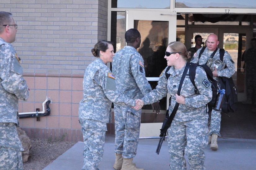 Capt. Stephanie Edinger, right, commander, 307th Military Police Company shakes hands with  Command Sgt. Maj. Karen Logan, left, command sergeant major, 2220th Mobilization Support Battalion, as Edinger walks to the aircraft that will that her to the Guantanamo Naval Base, Cuba, March 27.