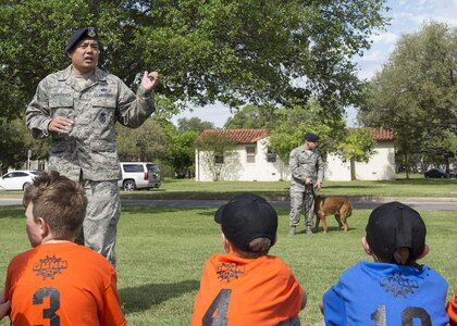 Staff Sgt. Michael Sengphradeth, 902nd Security Forces Squadron military working dog trainer, prepares to show a demonstration of the 902nd SFS MWDs during Famaganza at the Youth Programs Complex on JBSA-Randolph April 9, 2016. Part of Famaganza’s mission is to showcases JBSA-Randolph's community resources. 
