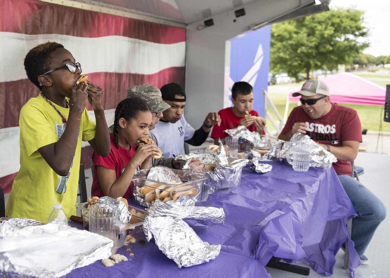 Participants compete in a hot dog eating contest during Famaganza at the Youth Programs complex on Joint Base San Antonio-Randolph April 9, 2016. Famaganza, hosted by the 502nd Force Support Squadron, is in its 20th year of operation. 