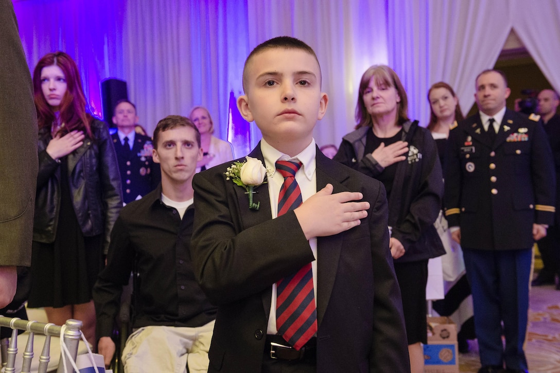 Christian Fagala, 9, stands during the playing of the national anthem at the Military Child of the Year Awards Gala in Arlington, Va., April 14, 2016. Fagala was honored with other military children who demonstrate leadership, resilience and strength of character. DoD photo by Army Staff Sgt. Sean K. Harp