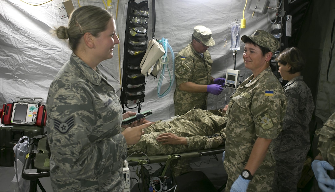 Air Force Staff Sgt. Anastasia Stuart, assigned to the 6th Medical Support Squadron, translates instructions about medical equipment in Zhytomyr, Ukraine, Aug 18, 2015. Stuart was selected by the Language Enabled Airman Program to interpret and translate between U.S and Ukrainian personnel. Courtesy photo