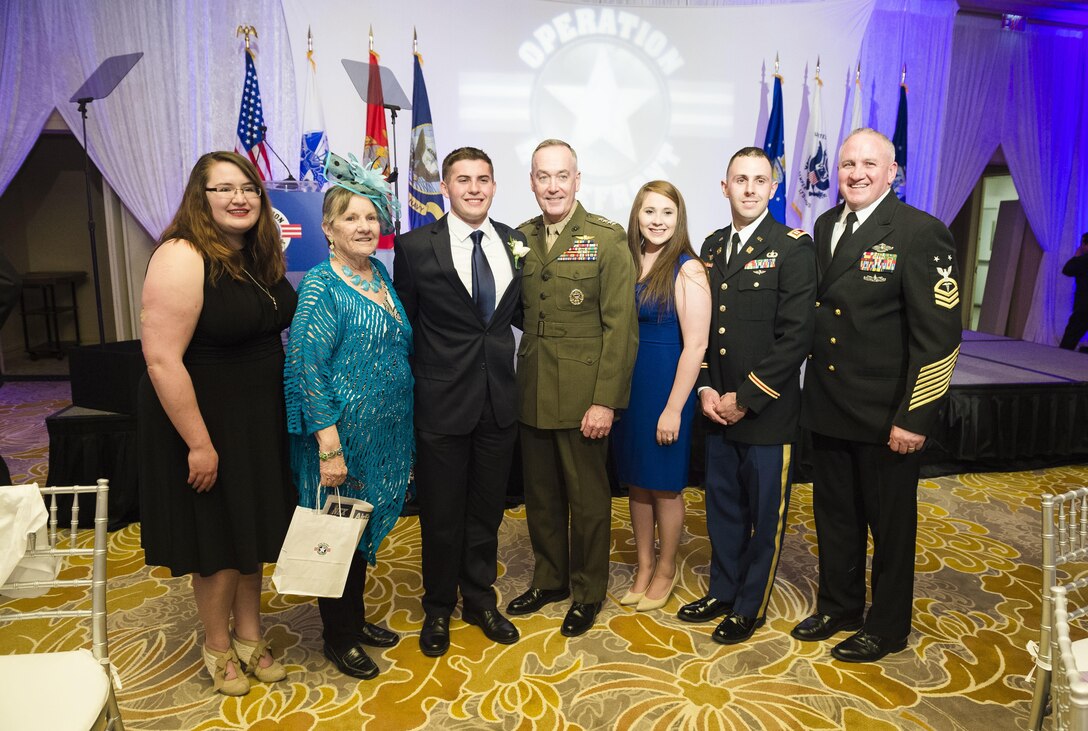 Marine Corps Gen. Joe Dunford, chairman of the Joint Chiefs of Staff, center, poses for a photograph with Jeffrey Burds and his family during the Military Child of the Year Awards Gala, in Arlington, Va., April 14, 2016. DoD photo by Army Staff Sgt. Sean K. Harp