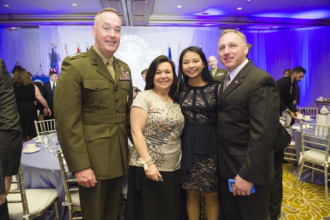 Marine Corps Gen. Joe Dunford, left, chairman of the Joint Chiefs of Staff, poses for a photograph with Madeleine Morlino and her parents during the Military Child of the Year Awards Gala in Arlington, Va., April 14, 2016. DoD photo by Army Staff Sgt. Sean K. Harp