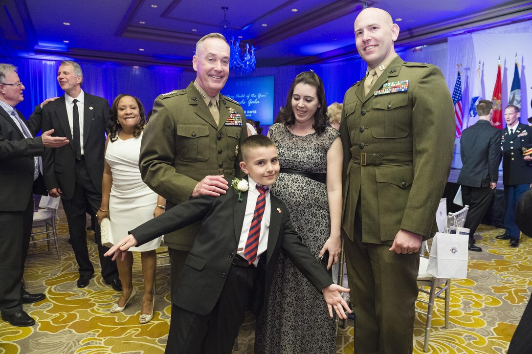 Marine Corps Gen. Joe Dunford, left, chairman of the Joint Chiefs of Staff, poses for a photograph with Christian Fagala and his parents during the Military Child of the Year Awards Gala in Arlington, Va., April 14, 2016. DoD photo by Army Staff Sgt. Sean K. Harp