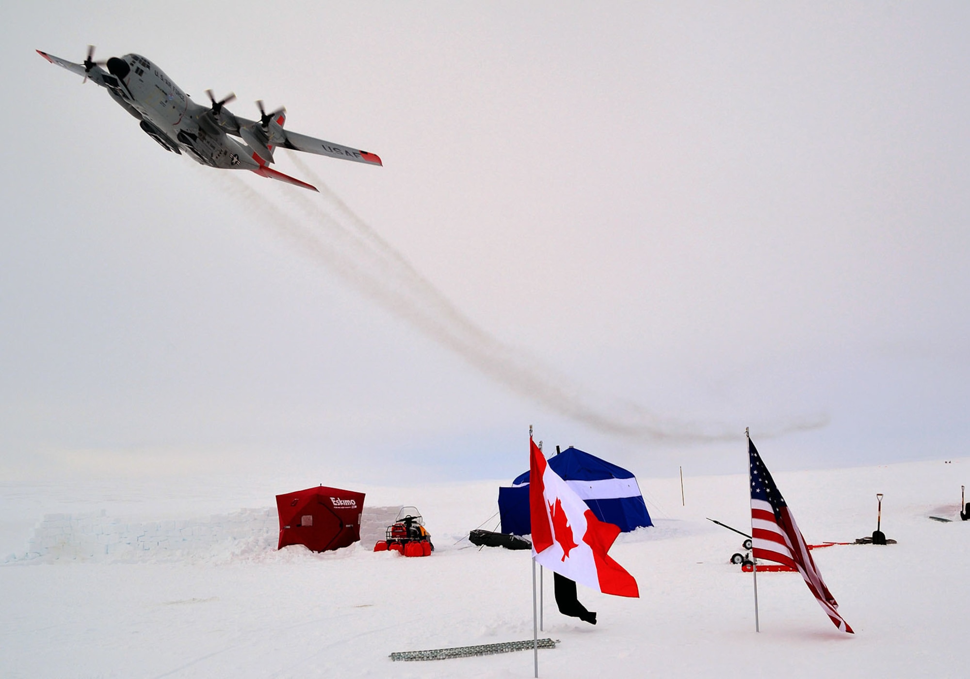 An LC-130 Hercules, assigned to the New York Air National Guard's 109th Airlift Wing, flies over an ice camp on Sherard Osborne Island, Nunavut, during Operation Nunalivut in 2014. The New York ANG flies the only ski-equipped C-130 aircraft in the world and is supporting this year’s exercise. (Courtesy photo/Canadian Armed Forces)