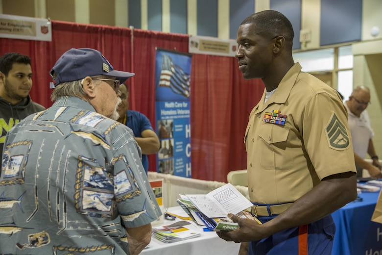 Staff Sgt. Wesley Alexander, construction foreman, Marine Wing Support Squadron 374, speaks to Navy veteran, Gary Brown, during the 6th Annual Veteran’s Expo at the Riverside County Fairgrounds in Indio, Calif., April 2, 2016. (Official Marine Corps photo by Lance Cpl. Levi Schultz/Released)