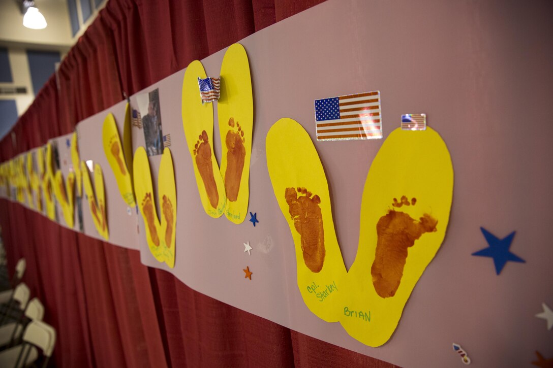 Footprints created by military children at the Combat Center Armed Services YMCA are displayed during the 6th Annual Veteran’s Expo at the Riverside County Fairgrounds in Indio, Calif., April 2, 2016. The children traced their active duty parent’s boot and used their feet to paint their prints in the center. (Official Marine Corps photo by Lance Cpl. Levi Schultz/Released)