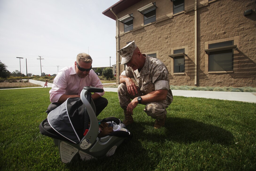 U.S. Marine Brig. Gen. David A. Ottignon meets a newborn baby during a uniformed victim advocate appreciation ceremony aboard Camp Pendleton, Calif., April 6, 2016. Ottignon is the commanding general of 1st Marine Logistics Group. These advocates provide information, guidance, and support to Marines and Sailors who have experienced sexual assault. Dozens of UVAs from around the Group were awarded certificates of appreciation for their hard work throughout the year. (U.S. Marine Corps photo by Sgt. Laura Gauna/released)