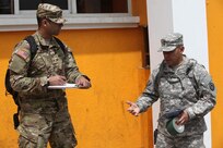 U.S. Army Master Sgt. Andres Canales with the 71st Theatre Information Operation Group and Cpl. Jonathan Soto with the 344th Psychological Operations have a discussion before meeting locals and passing out flyers at Palo Gordo, Guatemala, March 29, 2016. Task Force Red Wolf and Army South conducts Humanitarian Civil Assistance Training to include tactical level construction projects and Medical Readiness Training Exercises providing medical access and building schools in Guatemala with the Guatemalan Government and non-government agencies from 05MAR16 to 18JUN16 in order to improve the mission readiness of US Forces and to provide a lasting benefit to the people of Guatemala. (U.S. Army photo by Sgt. Prosper Ndow/Released)