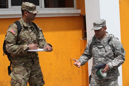 U.S. Army Master Sgt. Andres Canales with the 71st Theatre Information Operation Group and Cpl. Jonathan Soto with the 344th Psychological Operations have a discussion before meeting locals and passing out flyers at Palo Gordo, Guatemala, March 29, 2016. Task Force Red Wolf and Army South conducts Humanitarian Civil Assistance Training to include tactical level construction projects and Medical Readiness Training Exercises providing medical access and building schools in Guatemala with the Guatemalan Government and non-government agencies from 05MAR16 to 18JUN16 in order to improve the mission readiness of US Forces and to provide a lasting benefit to the people of Guatemala. (U.S. Army photo by Sgt. Prosper Ndow/Released)