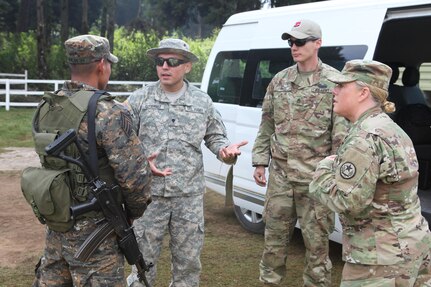 U.S. Army members talk to Guatemalan guard during a visit to a construction site for Operation Beyond The Horizon at Palo Gardo, Guatemala, March 29, 2016. Task Force Red Wolf and Army South conducts Humanitarian Civil Assistance Training to include tactical level construction projects and Medical Readiness Training Exercises providing medical access and building schools in Guatemala with the Guatemalan Government and non-government agencies from 05MAR16 to 18JUN16 in order to improve the mission readiness of US Forces and to provide a lasting benefit to the people of Guatemala. (U.S. Army photo by Sgt. Prosper Ndow/Released)