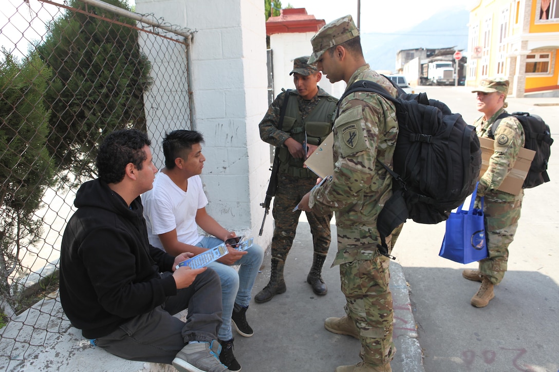 U.S. Army Cpl. Jonathan Soto with the 344th Psychological Operations hands out flyers and talks to locals about the upcoming free medical clinic that will be provided by the U.S. military at Palo Gordo, Guatemala, March 29, 2016. Task Force Red Wolf and Army South conducts Humanitarian Civil Assistance Training to include tactical level construction projects and Medical Readiness Training Exercises providing medical access and building schools in Guatemala with the Guatemalan Government and non-government agencies from 05MAR16 to 18JUN16 in order to improve the mission readiness of US Forces and to provide a lasting benefit to the people of Guatemala. (U.S. Army photo by Sgt. Prosper Ndow/Released)