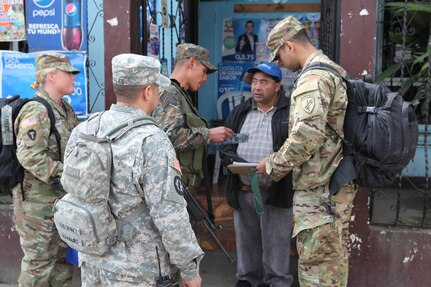 U.S. Army members walk the streets to pass out flyers and educate the local population about a free medical clinic that will be provided by the U.S. military at Palo Gardo, Guatemala, March 29, 2016. Task Force Red Wolf and Army South conducts Humanitarian Civil Assistance Training to include tactical level construction projects and Medical Readiness Training Exercises providing medical access and building schools in Guatemala with the Guatemalan Government and non-government agencies from 05MAR16 to 18JUN16 in order to improve the mission readiness of US Forces and to provide a lasting benefit to the people of Guatemala. (U.S. Army photo by Sgt.Prosper Ndow/Released)