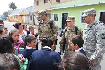 U.S. Army members are surrounded by school children and their teacher as they walk the streets to pass out flyers and educate the local population about a free medical clinic that will be provided by the U.S. military at Palo Gardo, Guatemala, March 29, 2016. Task Force Red Wolf and Army South conducts Humanitarian Civil Assistance Training to include tactical level construction projects and Medical Readiness Training Exercises providing medical access and building schools in Guatemala with the Guatemalan Government and non-government agencies from 05MAR16 to 18JUN16 in order to improve the mission readiness of US Forces and to provide a lasting benefit to the people of Guatemala. (U.S. Army photo by Sgt.Prosper Ndow/Released)