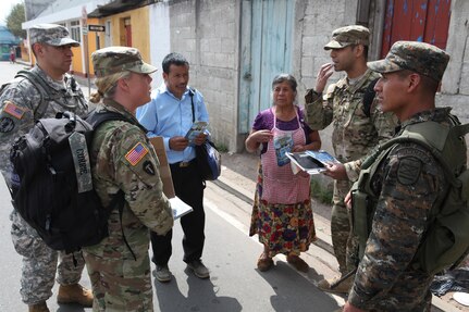 U.S. Army members walk the streets to pass out flyers and educate the local population about a free medical clinic that will be provided by the U.S. military at Palo Gardo, Guatemala, March 29, 2016. Task Force Red Wolf and Army South conducts Humanitarian Civil Assistance Training to include tactical level construction projects and Medical Readiness Training Exercises providing medical access and building schools in Guatemala with the Guatemalan Government and non-government agencies from 05MAR16 to 18JUN16 in order to improve the mission readiness of US Forces and to provide a lasting benefit to the people of Guatemala. (U.S. Army photo by Sgt.Prosper Ndow/Released)