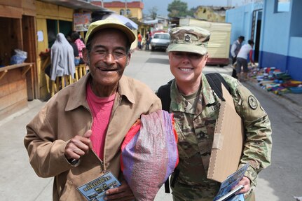 U.S. Army Sgt. 1st. Class Cheylynn Currie with the 71st Theatre Information Operation Group hands out flyers and talks to locals about an upcoming free medical clinic that will be provided by the U.S. military at Palo Gordo, Guatemala, March 29, 2016. Task Force Red Wolf and Army South conducts Humanitarian Civil Assistance Training to include tactical level construction projects and Medical Readiness Training Exercises providing medical access and building schools in Guatemala with the Guatemalan Government and non-government agencies from 05MAR16 to 18JUN16 in order to improve the mission readiness of US Forces and to provide a lasting benefit to the people of Guatemala. (U.S. Army photo by Sgt. Prosper Ndow/Released)