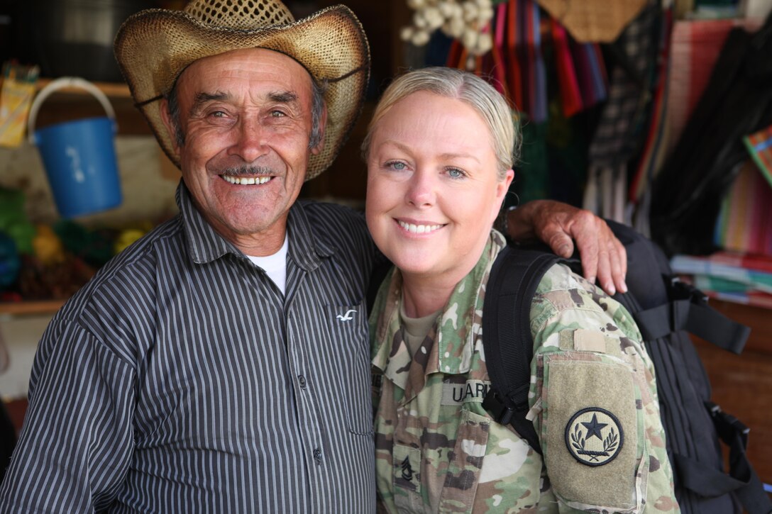 U.S. Army Sgt. 1st. Class Cheylynn Currie with the 71st Theatre Information Operation Group hands out flyers and talks to locals about an upcoming free medical clinic that will be provided by the U.S. military at Palo Gordo, Guatemala, March 29, 2016. Task Force Red Wolf and Army South conducts Humanitarian Civil Assistance Training to include tactical level construction projects and Medical Readiness Training Exercises providing medical access and building schools in Guatemala with the Guatemalan Government and non-government agencies from 05MAR16 to 18JUN16 in order to improve the mission readiness of US Forces and to provide a lasting benefit to the people of Guatemala. (U.S. Army photo by Sgt. Prosper Ndow/Released)