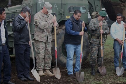 U.S. Army Lt. Col. Darrell Martin with Task Force (TF) Red Wolf wears his TF Red Wolf cap to support local city and military leaders break ground at the construction site for the Aldea Polopon clinic at Palo Gordo, Guatemala, March 29, 2016. TF Red Wolf and Army South conducts Humanitarian Civil Assistance Training to include tactical level construction projects and Medical Readiness Training Exercises providing medical access and building schools in Guatemala with the Guatemalan Government and non-government agencies from 05MAR16 to 18JUN16 in order to improve the mission readiness of US Forces and to provide a lasting benefit to the people of Guatemala. (U.S. Army photo by Sgt. Prosper Ndow/Released)