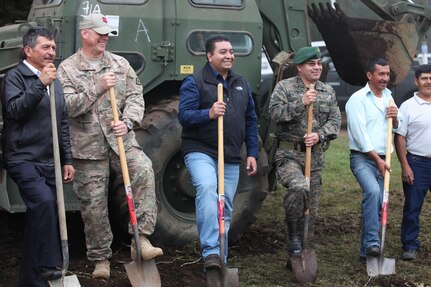 U.S. Army Lt. Col. Darrell Martin with Task Force (TF) Red Wolf wears his TF Red Wolf cap to support local city and military leaders break ground at the construction site for the Aldea Polopon clinic at Palo Gordo, Guatemala, March 29, 2016. TF Red Wolf and Army South conducts Humanitarian Civil Assistance Training to include tactical level construction projects and Medical Readiness Training Exercises providing medical access and building schools in Guatemala with the Guatemalan Government and non-government agencies from 05MAR16 to 18JUN16 in order to improve the mission readiness of US Forces and to provide a lasting benefit to the people of Guatemala. (U.S. Army photo by Sgt. Prosper Ndow/Released)