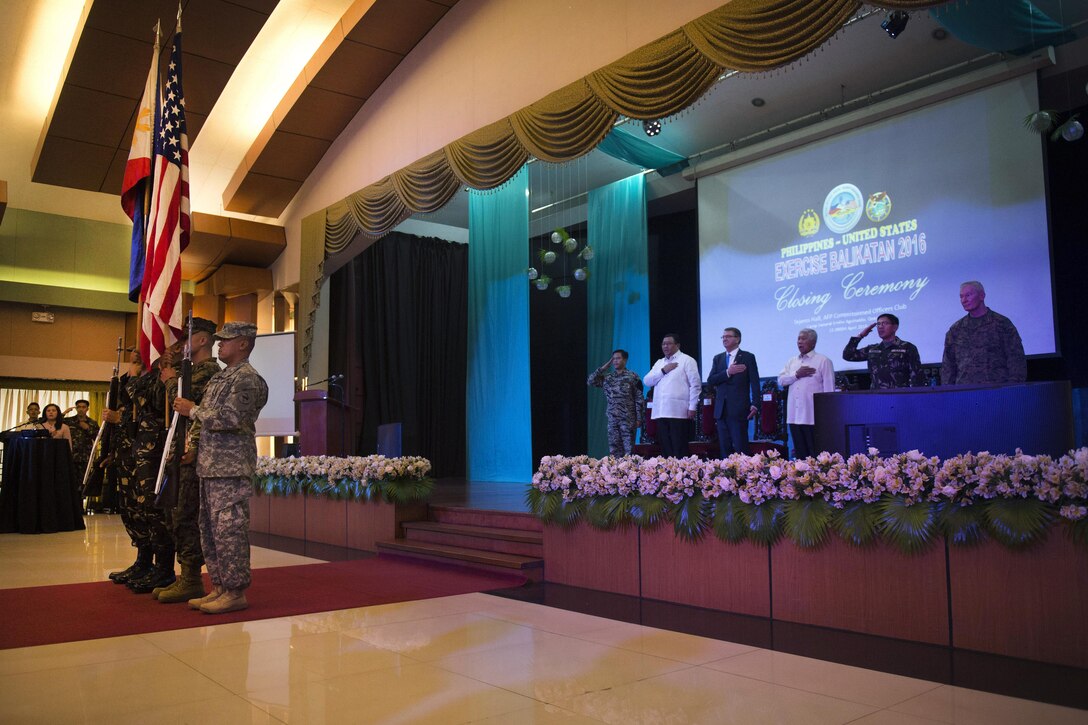 Defense Secretary Ash Carter, background, center left; Philippine Defense Secretary Voltaire Gazmin, background, center right; and other leaders render honors during the closing ceremony of joint Exercise Balikatan 2016 in Manila, Philippines, April 15, 2016. Carter is visiting the Philippines to solidify the U.S. rebalance to the Asia-Pacific region. DoD photo by Air Force Senior Master Sgt. Adrian Cadiz