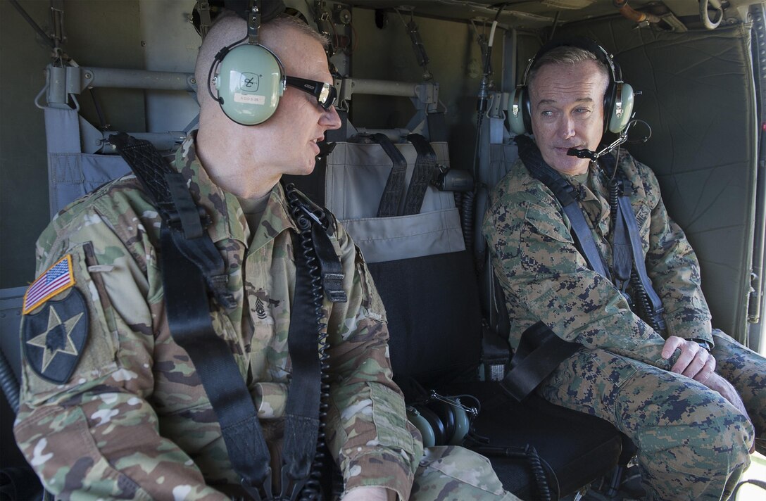 Army Command Sgt. Maj. John W. Troxell, senior enlisted advisor to the chairman of the Joint Chiefs of Staff, speaks to Marine Corps Gen. Joe Dunford, the chairman of the Joint Chiefs of Staff, aboard a UH-60 Black Hawk helicopter in Hawaii, Feb. 9, 2016. DoD photo by Navy Petty Officer 2nd Class Dominique A. Pineiro