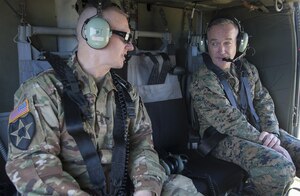 Army Command Sgt. Maj. John W. Troxell, senior enlisted advisor to the chairman of the Joint Chiefs of Staff, speaks to Marine Corps Gen. Joe Dunford, the chairman of the Joint Chiefs of Staff, aboard a UH-60 Black Hawk helicopter in Hawaii, Feb. 9, 2016. DoD photo by Navy Petty Officer 2nd Class Dominique A. Pineiro