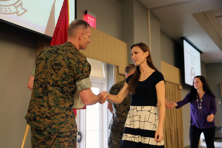 Maj. Gen. Gary L. Thomas congratulates a volunteer during an award ceremony at Marine Corps Air Station Cherry Point, N.C., April 12, 2016. The award ceremony was held to recognized the more than 90,000 volunteer hours collectively accomplished by members of the air station community. Senior leaders represented their units, along with DOD employees and service family volunteers as they received individual recognition for their volunteer efforts and the positive impact they have on the air station. Thomas is the 2nd Marine Aircraft Wing commanding general. (U.S. Marine Corps photo by Cpl. N.W. Huertas/Released)