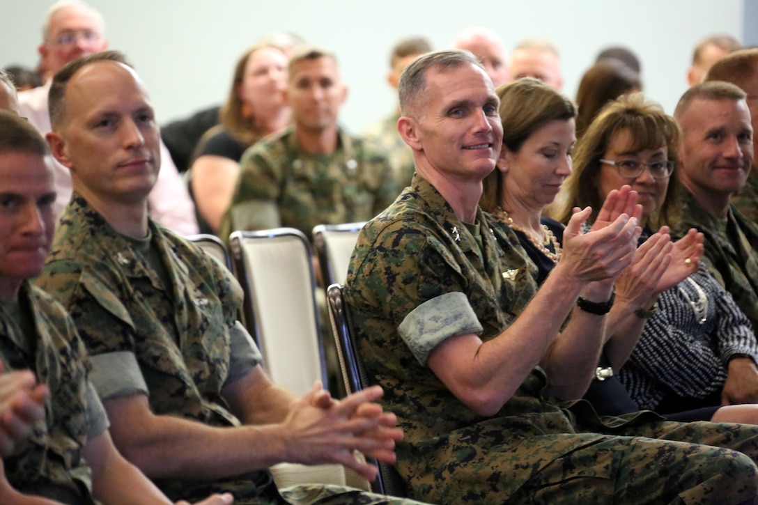 Col. Chris Pappas III, (left) and Maj. Gen. Gary L. Thomas congratulate volunteers during a volunteer appreciation award ceremony at Marine Corps Air Station Cherry Point, N.C., April 12, 2016. The award ceremony was held to recognize the more than 90,000 volunteer hours collectively accomplished by members of the air station community. Senior leaders represented their units along with DOD employees and service family volunteers as they received individual recognition for their volunteer efforts and the positive impact they have on the air station. Thomas is the 2d Marine Aircraft Wing commanding general and Pappas is the Cherry Point commanding officer. (U.S. Marine Corps photo by Cpl. N.W. Huertas/Released)