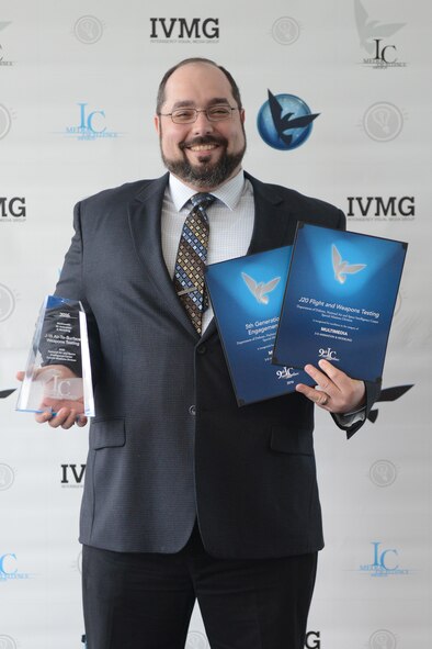 Justin Weisbarth. a contractor from Ball Aerospace and Technology Corporation and a member of NASIC’s Threat Visualization team, celebrates his three finalist awards during the Intelligence Community Media Excellence Awards ceremony at National Reconnaissance Office Virginia, March 17. This marks the first time a NASIC member has won an ICy award. 
