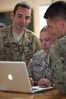 From the left, U.S. Army Sgt. Austin Berner, Staff Sgt. Edward Reagan, and Staff Sgt. Justin Morelli, each assigned to the 982nd Combat Camera Company (Airborne), review photos captured of Operation Skyfall USA (OS-U) on Fort Gordon, Ga., April 12, 2016. OS-U is a 982nd Combat Camera Company (Airborne) Theater Security Cooperation initiative. OS-U is a joint, multi-component, multi-lateral Combat Camera subject matter expert exchange taking place in multiple locations in Georgia. OS-U is part of a series that includes OS-Deutschland, OS-France, and OS-Kosovo. (U.S. Army photo by Spc. Joshua Wooten/Released)