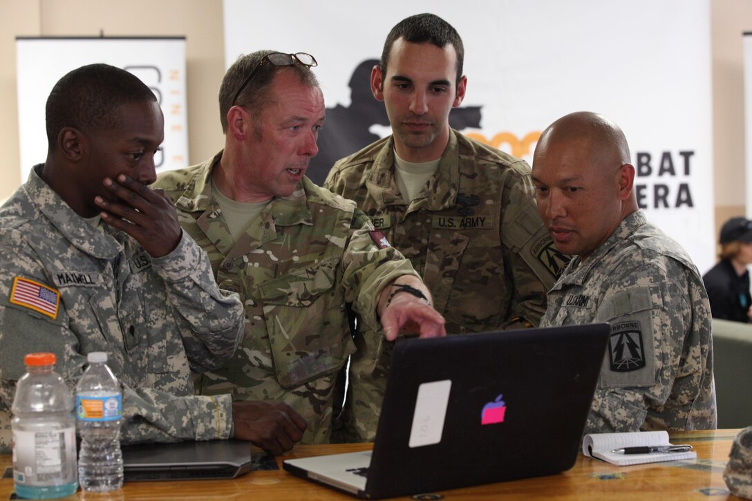 U.S. and U.K. service members review and discuss photos captured during Operation Skyfall USA (OS-U) on Fort Gordon, Ga., April 12, 2016. OS-U is a 982nd Combat Camera Company (Airborne) Theater Security Cooperation initiative. OS-U is a joint, multi-component, multi-lateral Combat Camera subject matter expert exchange taking place in multiple locations in Georgia. OS-U is part of a series that includes OS-Deutschland, OS-France, and OS-Kosovo. (U.S. Army photo by Spc. Joshua Wooten/Released)