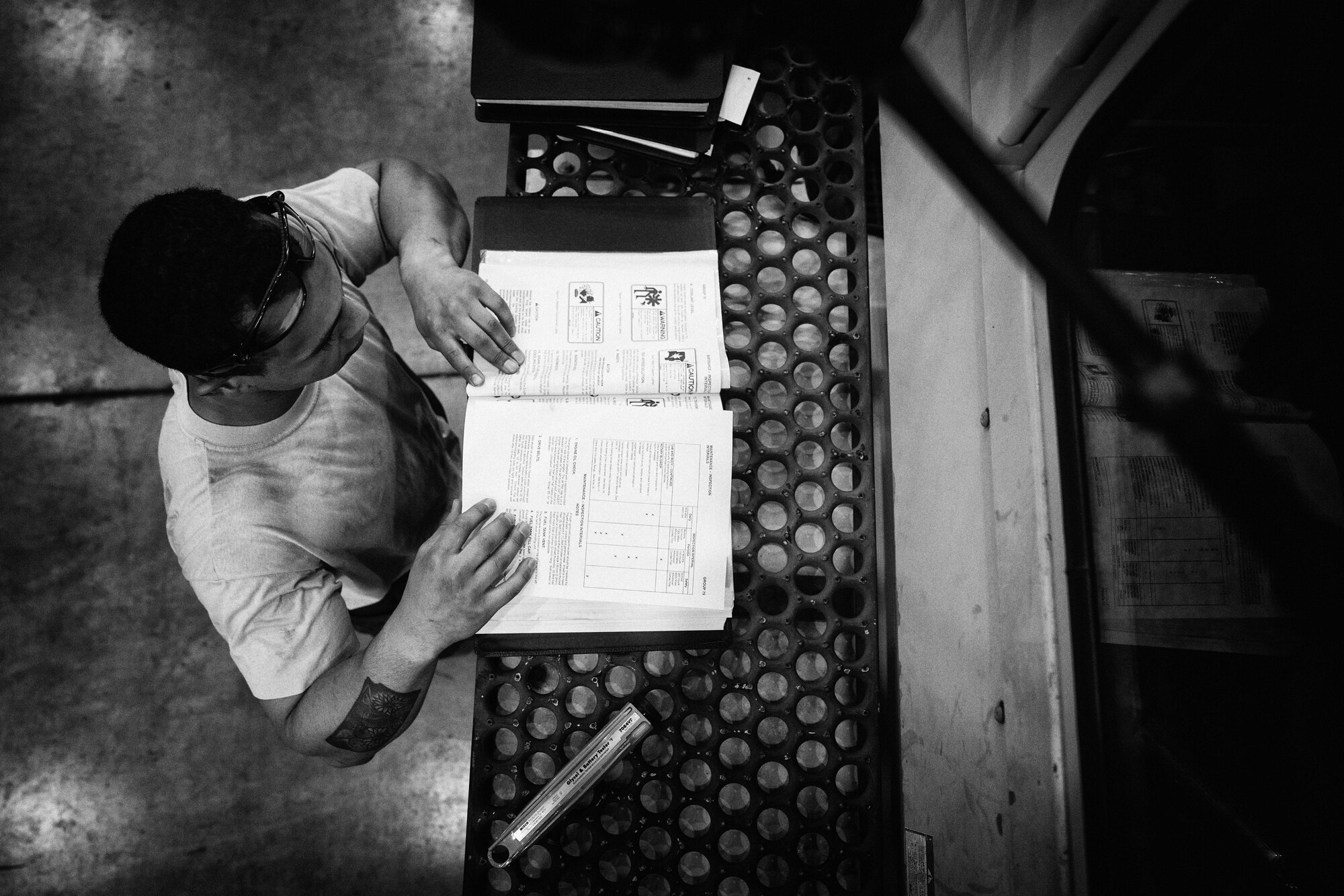 U.S. Air Force Senior Airman Stephen Royer, 374th Logistics Readiness Squadron vehicle maintenance journeyman, reviews technical orders before repairing a snow sweeper at Yokota Air Base, Japan, April 13, 2016. During the spring and summer, the vehicle maintenance shop inspects and service the base’s snow equipment to ensure that it’s ready for the next winter. (U.S. Air Force photo by Senior Airman Delano Scott/Released)