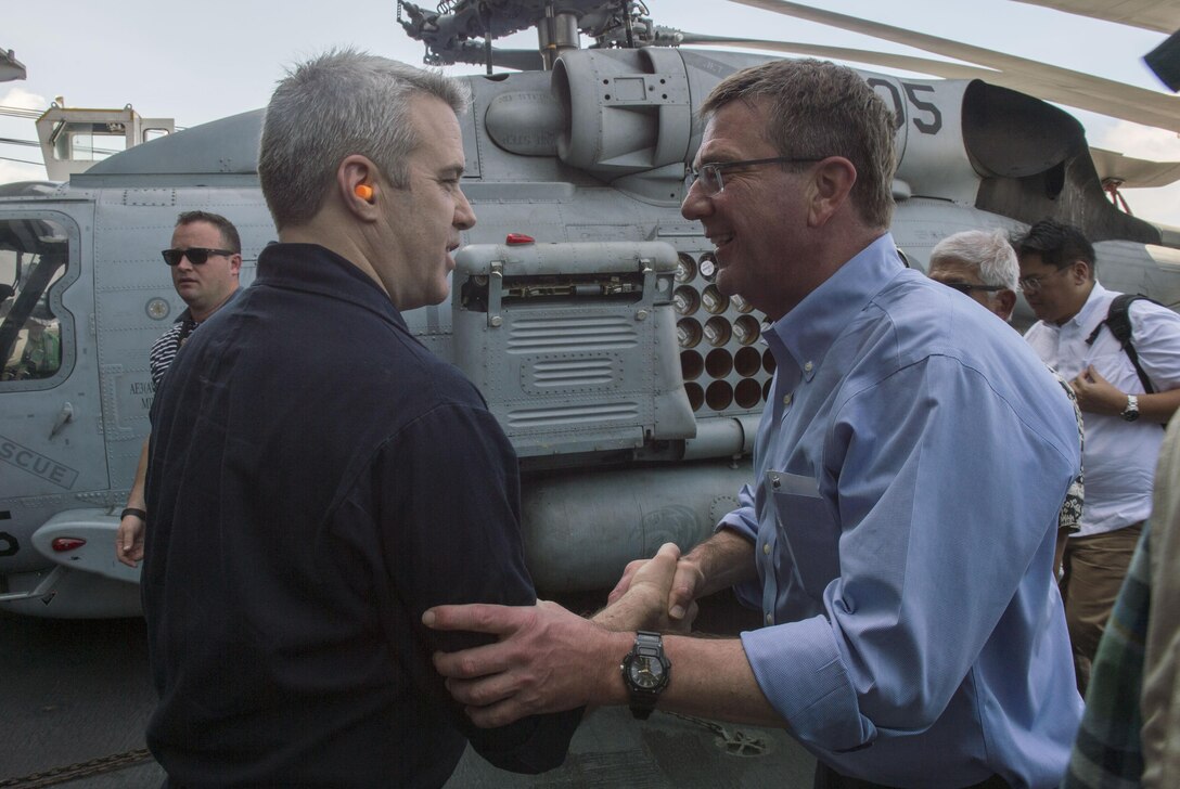 Defense Secretary Ash Carter, right, exchanges greetings with Navy Rear Adm. Ronald A. Boxall upon arriving with Philippine Defense Secretary Voltaire Gazmin aboard the USS John C. Stennis to tour the aircraft carrier in the South China Sea, April 15, 2016. Boxall is commander of Carrier Strike Group 3. DoD photo by Air Force Senior Master Sgt. Adrian Cadiz