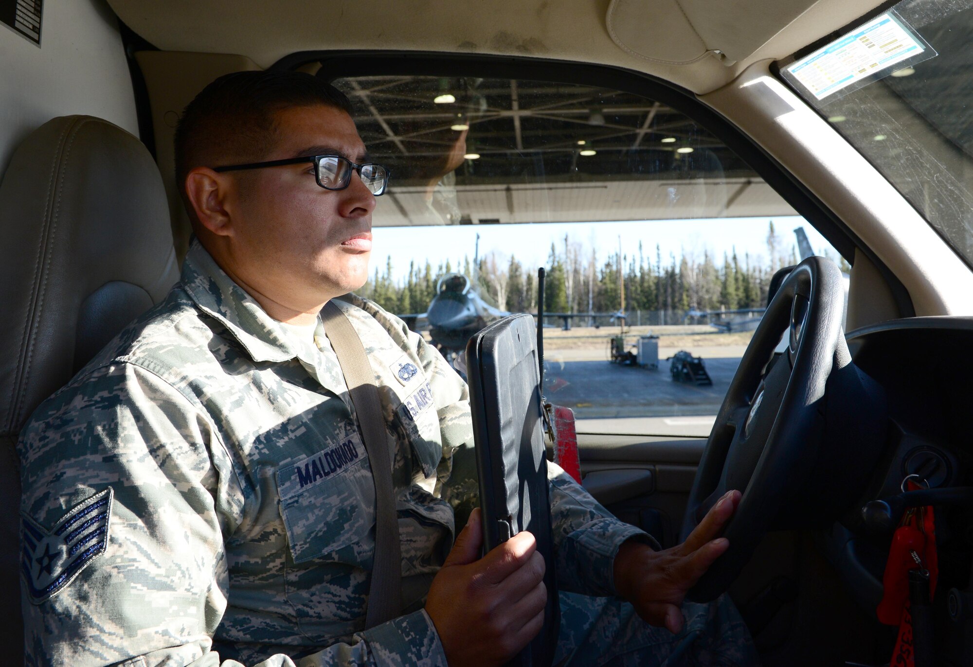 U.S. Air Force Staff Sgt. Jacob Maldonado, a 354th Aircraft Maintenance squadron weapons expediter, drives a MIG-6 box truck April 13, 2016, at Eielson Air Force Base, Alaska. Maldonado drives around to verify personnel safety, pilot safety and to make sure everyone follows technical order. (U.S. Air Force photo by Airman 1st Class Cassandra Whitman/Released)