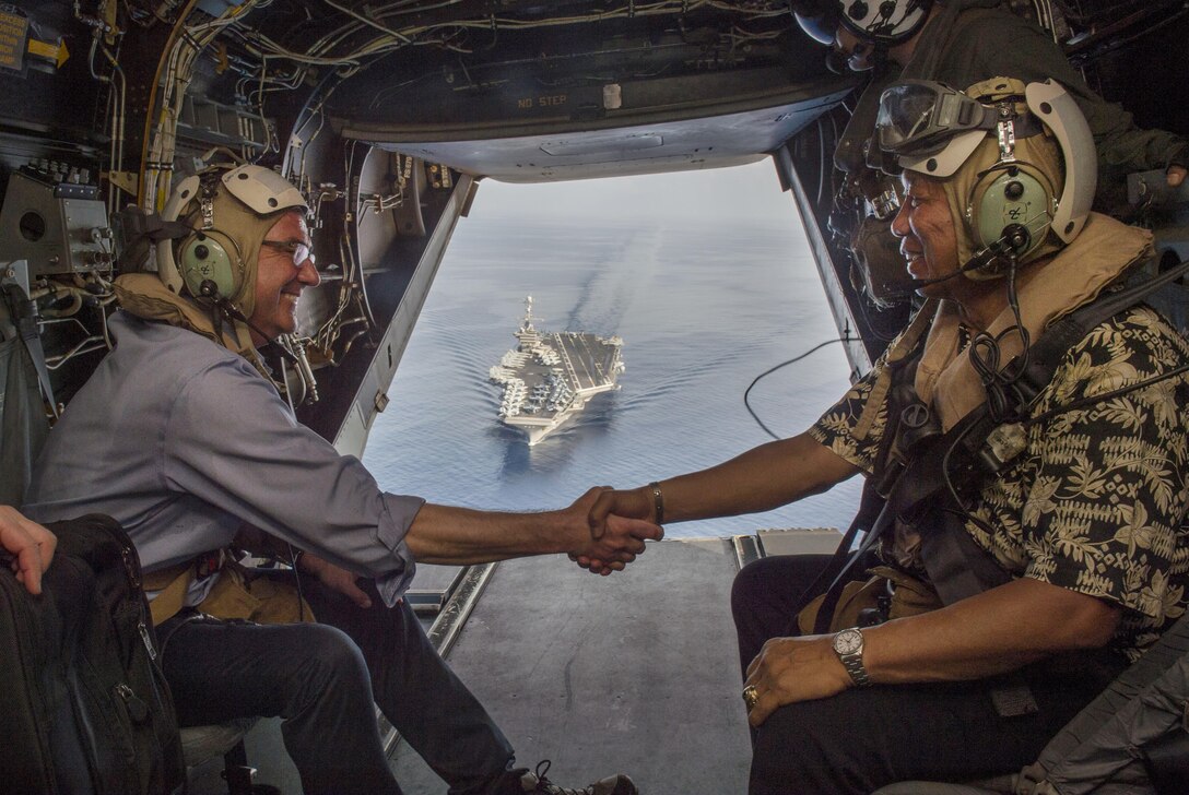 Defense Secretary Ash Carter shakes hands with Philippine Defense Secretary Voltaire Gazmin aboard a Marine Corps MV-22 Osprey as they depart from the USS John C. Stennis in the South China Sea, April 15, 2016. DoD photo by Air Force Senior Master Sgt. Adrian Cadiz