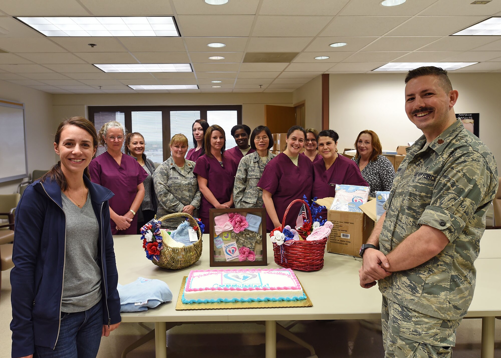 Maj. Nicholas Carr, 959th Medical Group staff neonatologist, and members of his team present a small shadow box to Kelly Banachowski, Wilford Hall Auxiliary service chair, in recognition of the WHA’s support to the Safe to Sleep campaign March 23 at the San Antonio Military Medical Center. The WHA donated Halo SleepSack blankets to the Maternal-Child unit at SAMMC to send home with newborns to help promote safe sleeping habits. (U.S. Air Force photo/Tech. Sgt. Christopher Carwile)