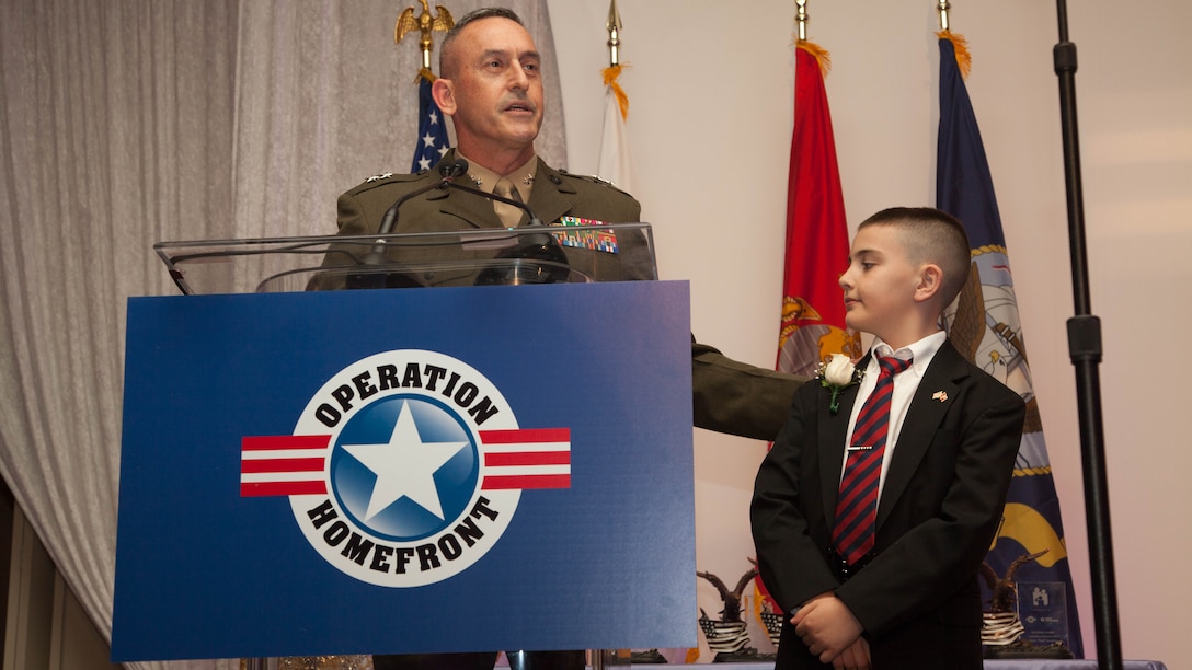 Maj. Gen. James W. Lukeman speaks on behalf of Christian Fagala during the 2016 Military Child of the Year Award Ceremony April 14, at the Ritz-Carlton Hotel. According to the Operation Homefront website, the award recognizes military children who have demonstrated themselves as exceptional citizens while facing the challenges of military family life. Christian, 9, is the Marine Corps recipient of the award. 