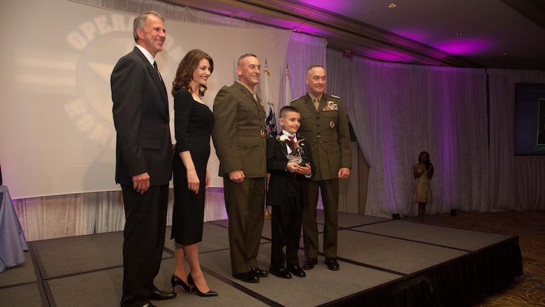 Christian Fagala receives the Military Child of the Year Award during the 2016 Military Child of the Year Award Ceremony April 14, at the Ritz-Carlton Hotel. According to the Operation Homefront website, the award recognizes military children who have demonstrated themselves as exceptional citizens while facing the challenges of military family life. Christian, 9, is the Marine Corps recipient of the award. 