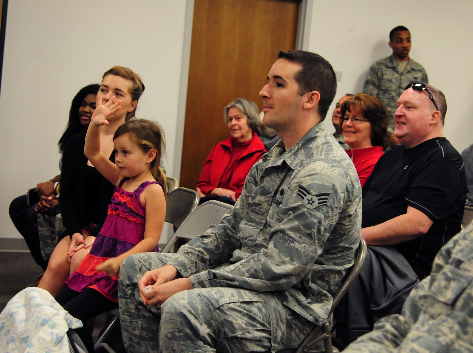 Aaliayah raises her hand to indicate that it’s her birthday during an open house hosted by the 548th Intelligence, Surveillance and Reconnaissance Group at Beale Air Force Base, April 13, 2016.  Members of the audience joined Col. Drew Taylor in singing “Happy Birthday” to Aaliayah and presented her with a cake. (U.S. Air Force photo by Staff Sgt. Zachary Vucic) 