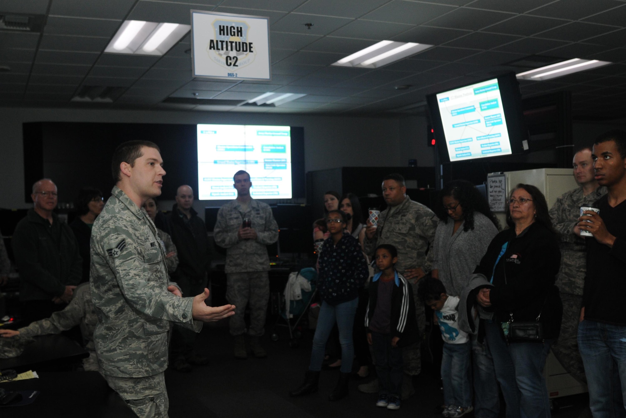 Senior Airman Christopher explains the importance if signals intelligence to Airmen and their families at an open house hosted by the 548th Intelligence, Surveillance and Reconnaissance Group at Beale Air Force Base on April 13, 2016. The 548th ISR Group opened their doors, allowing family members to get an inside look at the work their Airmen do on a daily basis. (U.S. Air Force photo by Airman 1st Class Jessica B. Nelson)