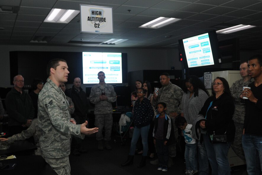 Senior Airman Christopher explains the importance if signals intelligence to Airmen and their families at an open house hosted by the 548th Intelligence, Surveillance and Reconnaissance Group at Beale Air Force Base on April 13, 2016. The 548th ISR Group opened their doors, allowing family members to get an inside look at the work their Airmen do on a daily basis. (U.S. Air Force photo by Airman 1st Class Jessica B. Nelson)