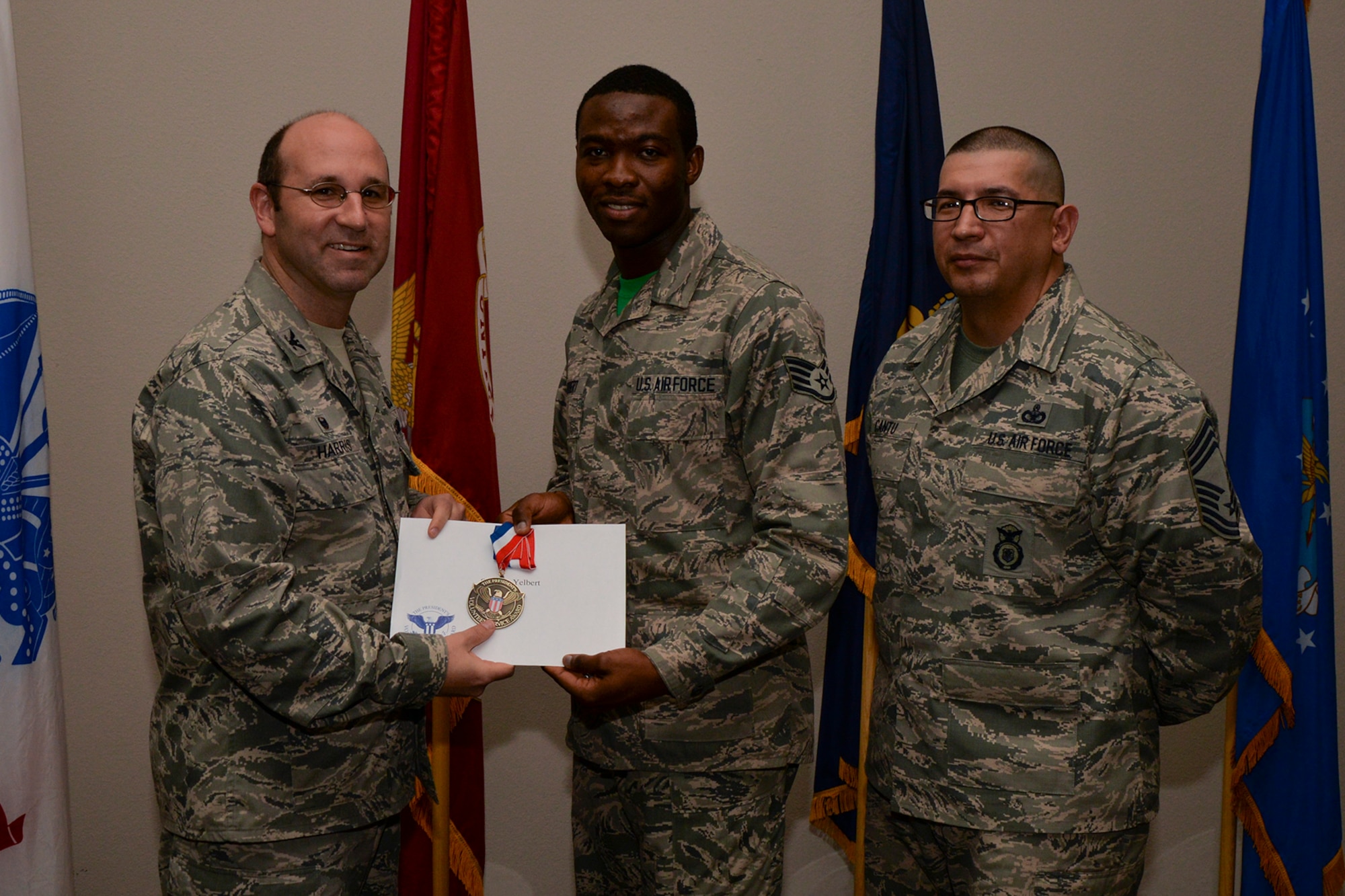 U.S. Air Force Col. Christopher Harris, 17th Mission Support Group Commander, and Chief Master Sgt. Jessie Cantu, 17th MSG acting superintendent, present the President’s Volunteer Service Award Bronze medal to Staff Sgt. Stephen Yelbert, 17th Comptroller Squadron, during the volunteer recognition ceremony at the Event Center on Goodfellow Air Force Base, Texas, April 15, 2016. The bronze medal is awarded to individuals who logged between 100 and 249 volunteer hours. (U.S. Air Force photo by Airman 1st Class Randall A.S. Moose/Released)