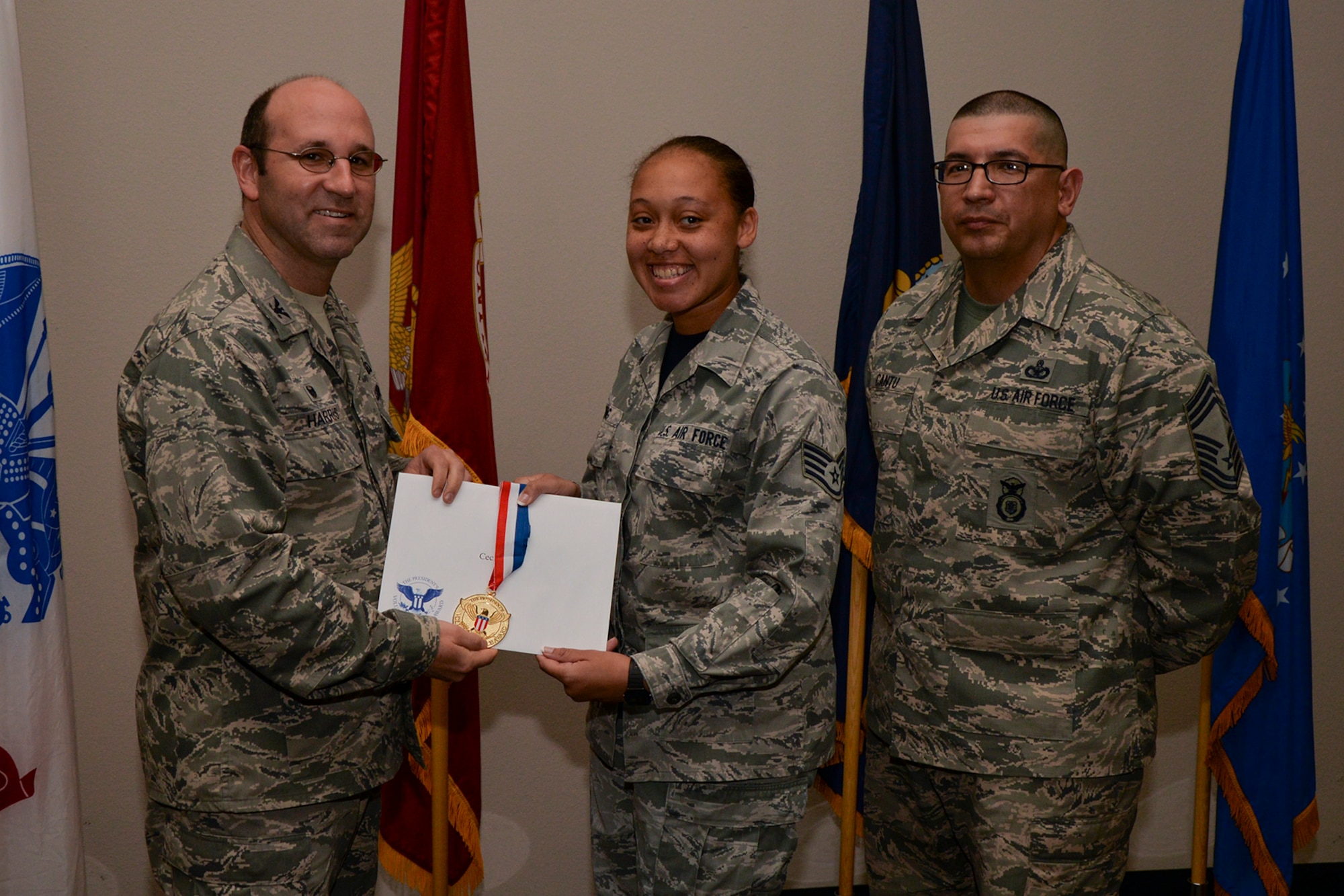 U.S. Air Force Col. Christopher Harris, 17th Mission Support Group Commander, and Chief Master Sgt. Jessie Cantu, 17th MSG acting superintendent, present the President’s Volunteer Service Award Gold medal to Staff Sgt. Cecile King, 315th Training Squadron, during the volunteer recognition ceremony at the Event Center on Goodfellow Air Force Base, Texas, April 15, 2016. The gold medal is awarded to individuals who logged 500 or more volunteer hours. (U.S. Air Force photo by Airman 1st Class Randall A.S. Moose/Released)