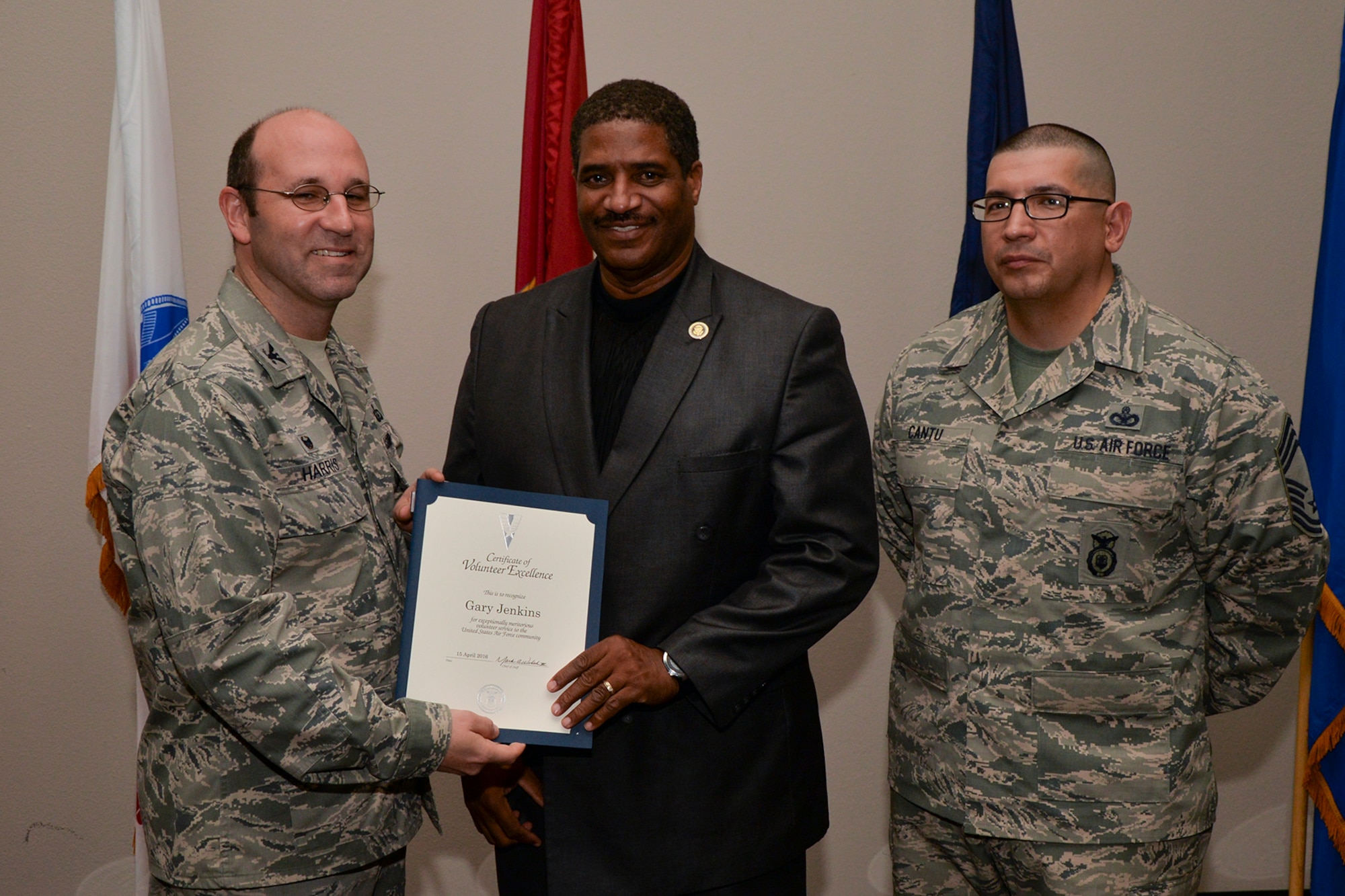 U.S. Air Force Col. Christopher Harris, 17th Mission Support Group Commander, and Chief Master Sgt. Jessie Cantu, 17th MSG acting superintendent, present the Volunteer Excellence Award to Gary Jenkins, 17th Training Wing Public Affairs, during the volunteer recognition ceremony at the Event Center on Goodfellow Air Force Base, Texas, April 15, 2016. The Volunteer Excellence Award recognizes federal civilian employees, family members, and federal civilian and military retirees who perform outstanding volunteer community service of a sustained, direct and consequential nature. (U.S. Air Force photo by Airman 1st Class Randall A.S. Moose/Released)