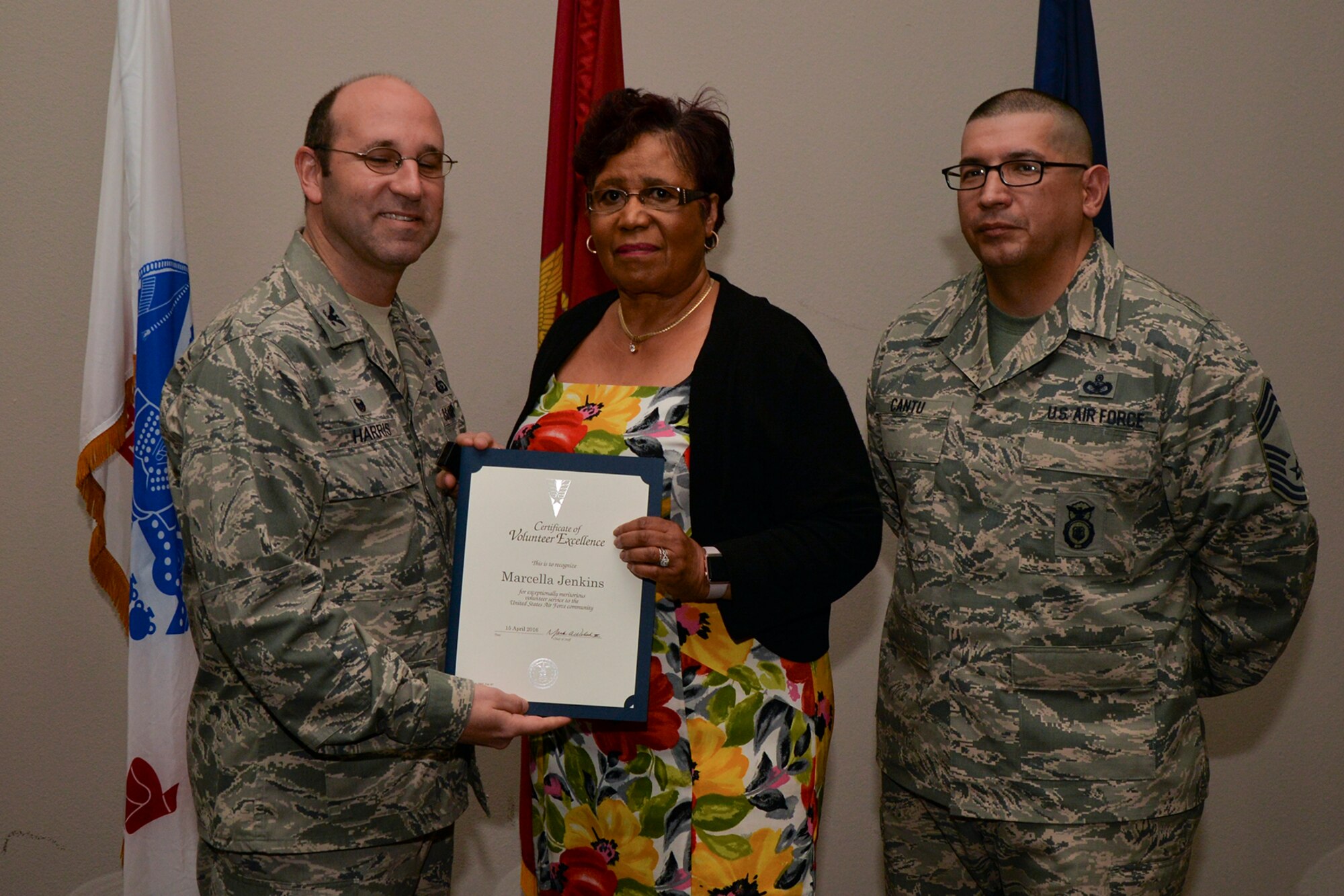 U.S. Air Force Col. Christopher Harris, 17th Mission Support Group Commander, and Chief Master Sgt. Jessie Cantu, 17th MSG acting superintendent, present the Volunteer Excellence Award to Marcella Jenkins during the volunteer recognition ceremony at the Event Center on Goodfellow Air Force Base, Texas, April 15, 2016. The Volunteer Excellence Award recognizes federal civilian employees, family members, and federal civilian and military retirees who perform outstanding volunteer community service of a sustained, direct and consequential nature. (U.S. Air Force photo by Airman 1st Class Randall A.S. Moose/Released)