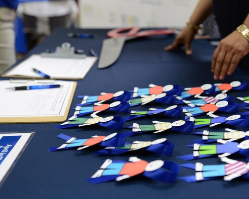 Miniature replicas of Cardboard Kids lay on a table at the Plaza Del Sol Mall in Del Rio, Texas, recently. Cardboard Kids are a representation of the children who suffer abuse and neglect every year. (U.S. Air Force photo by Senior Airman Jimmie D. Pike)